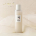 Applying GLOW REPLENISHING RICE MILK for hydrated skin